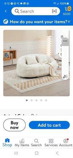 a white couch sitting on top of a wooden floor next to a blue and white rug