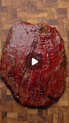 a large piece of meat sitting on top of a wooden cutting board