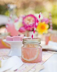 a mason jar with a pink and yellow striped straw