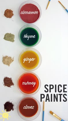 three bowls filled with different types of spices next to paintbrushes on a white surface