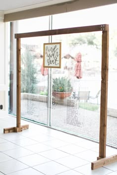 an empty room with white tile flooring and glass doors