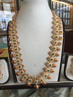 an elaborate necklace and matching earrings on display