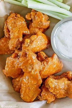 chicken wings with ranch dip and celery sticks on the side, ready to be eaten