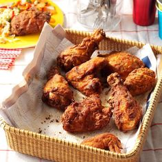 some fried chicken in a basket on a table