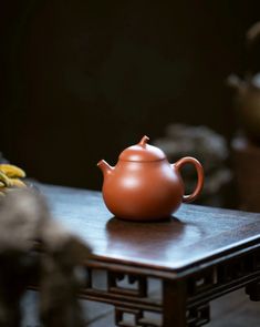 a tea pot sitting on top of a wooden table