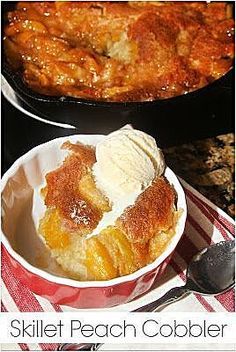 skillet peach cobbler with ice cream in a red bowl on a checkered table cloth