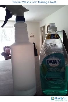 a close up of a bottle of detergent next to a cleaning spray on a table