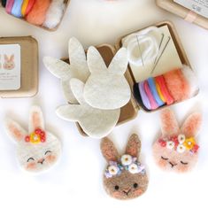 some little felt bunnies are sitting in a box