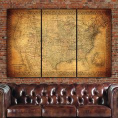 a couch in front of a brick wall with a large map hanging on the wall