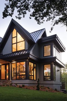 a large house with lots of windows on the front and side of it's roof