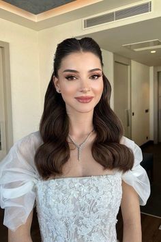 a woman with long hair wearing a white dress