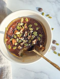 a bowl filled with pudding and nuts on top of a table