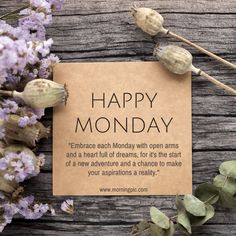 a piece of paper with the words happy monday written on it next to dried flowers