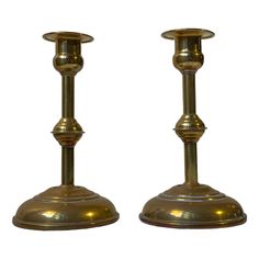 pair of brass candlesticks on white background