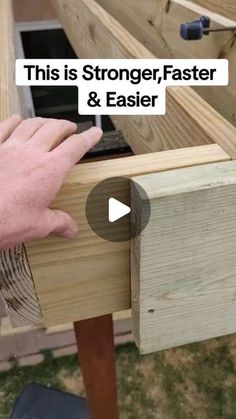 a person is holding something in their hand and pointing to the side of a wooden box