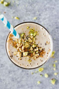 an overhead view of a smoothie topped with nuts