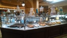 a display case in a store filled with lots of cakes and desserts on top of it