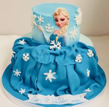 a frozen princess cake with blue frosting and white snowflakes