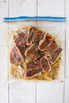 raw meat in a plastic bag on a white wooden table