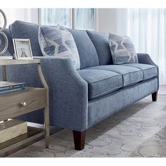 a living room with a blue couch and table