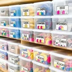 plastic bins filled with lots of different types of crafting supplies on a shelf