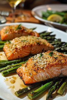 two salmons and asparagus on a white plate