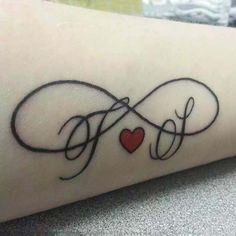 a cross and heart tattoo with the word love written in cursive writing on someone's arm