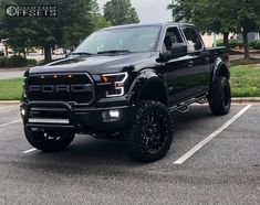 a black truck parked in a parking lot