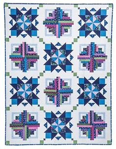 a blue and white quilt with many different designs on it's sides, including crosses