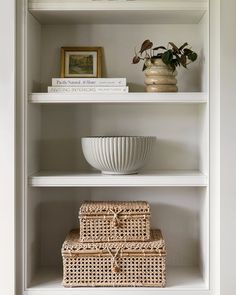 white shelves with wicker baskets and books