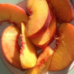 sliced peaches are on a plate ready to be eaten