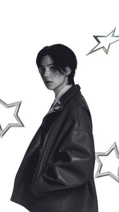 a black and white photo of a person wearing a coat with stars in the background