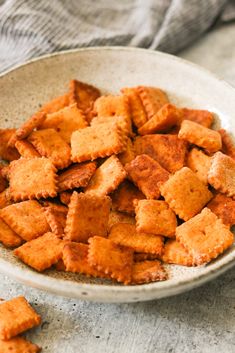 a white bowl filled with crackers on top of a table