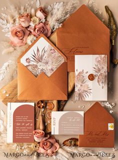 the wedding stationery is laid out with flowers