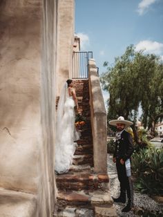 a bride and groom are standing on the stairs