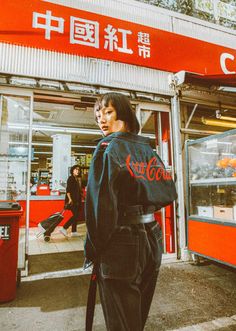 a woman standing in front of a store