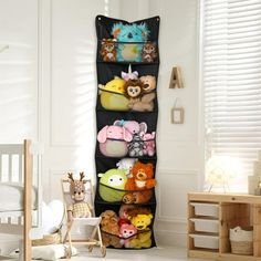 a child's room with stuffed animals and toys on the wall hanging from it