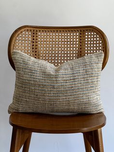 a wooden chair with a cushion on it