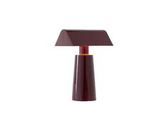 a brown table lamp with a red shade on it's base and a white background