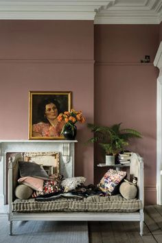 a living room filled with furniture and a painting on the wall