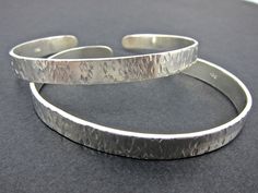 This hammered sterling silver cuff is adjustable to most sizes and can be worn many different ways.  Wear one at a time or a whole stack of them, or combine with a slightly different yet matching cuff as shown in one of the photos. a great addition to your jewelry stash and a quick way to change a look. These cuffs are about 7mm wide. If you would like to have more than two or a different width just let me know and I'll be happy to make it. The price of $65.00 is for one cuff. For more bracelets Keum Boo Earrings, 22k Gold Earrings, Simple Bangle, Mixed Metal Earrings, Peridot Earrings, Hammered Sterling Silver, Sterling Silver Cuff Bracelet, Sterling Silver Cuff, Metal Earrings