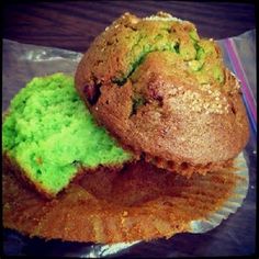 two muffins with green frosting on top of each one sitting on a piece of tin foil