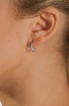 Sparkly cubic zirconia highlight twisted huggie hoop earrings plated in gleaming rhodium for a high-shine finish. 1/2" hoop diameter Snap-post closure Rhodium plate/cubic zirconia Imported Ring Watch, Flip Flop Slippers, Clutch Pouch, Sweaters And Leggings, Huggie Hoop Earrings, Keep Jewelry, Luxury Gifts, Beauty Gift