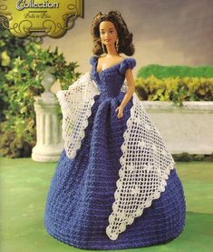 a crocheted doll in a blue dress