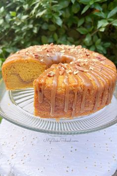 a bundt cake on a glass plate with a slice cut out and ready to be eaten