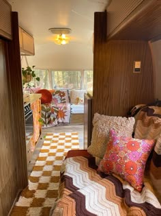 the inside of a camper with lots of pillows