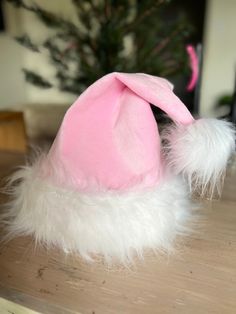 Baby pink / pastel pink Santa hat  Fits loosely on my 3 year old.  Perfect on female adult and can fit on my husband's head also!  Made from -super soft mink fabric  -faux fur white  Hat is lined with interfacing so you can stand straight up or bend for a slouch style hat All handmade by me Cute Pink Bonnet With Curved Brim, Playful Pink Mini Hat, One Size Fits Most, Playful Pink Mini Hats, One Size Fits Most, Playful Pink Mini Hats (one Size Fits Most), Pink Fun Costume Cap, Fun Pink Cap Style Hat, Cute Pink Party Hat, Playful Pink Mini Hat, Cute Pink Mini Cap Hat