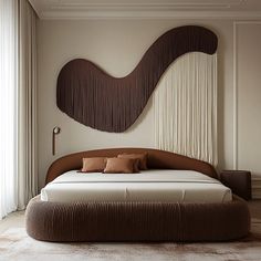 a large bed sitting in the middle of a room next to a wall mounted sculpture