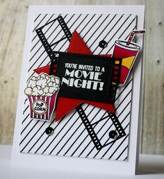 a close up of a card with a movie night theme on it and a cup of popcorn