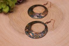 Item Overview *Handmade item *Raw Copper Patina *Ships anywhere in the US from Bellingham, Washington Item Details Unique Copper patina hoop earrings. Made of raw copper that has hand hammered, domed and Patinated by me Patina is a passion of mine because we love the results.  This process of this coloring of patina takes five days.   This pair is a beautiful copper earrings is accented with black, blues, greens, burnt orange and bronze hues.   This coloring is different every time and it's own unique piece Patina is a unique finish and no two pair will be exactly alike but will strongly resemble the picture. Product Overview - Hand hammered, dome shaped and patina - Very light weight and versatile -The copper patina pieces are covered by a thin layer of lacquer in order to save natural co Artisan Small Hoop Copper Jewelry, Copper Drop Hoop Earrings As Gift, Handmade Small Hoop Copper Earrings, Small Hoop Copper Jewelry, Handmade Small Copper Hoop Earrings, Copper Dangle Hoop Earrings Gift, Copper Circle Earrings For Gifts, Unique Small Hoop Copper Earrings, Handmade Copper Round Hoop Earrings